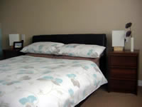 A double leather bed with quality mattress for a good nights sleep